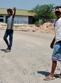 Chlapci v Kambodži zastavují auto