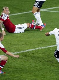 Germany&#039;s Lukas Podolski scores the opening goal during the Euro 2012 soccer championship Group B match between Denmark and Germany in Lviv, Ukraine, Sunday, June 17, 2012. (AP Photo/Michael Probst)