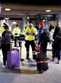 Policisté kontrolují doklady cestujících na nádraží u kodaňského letiště Kastrup